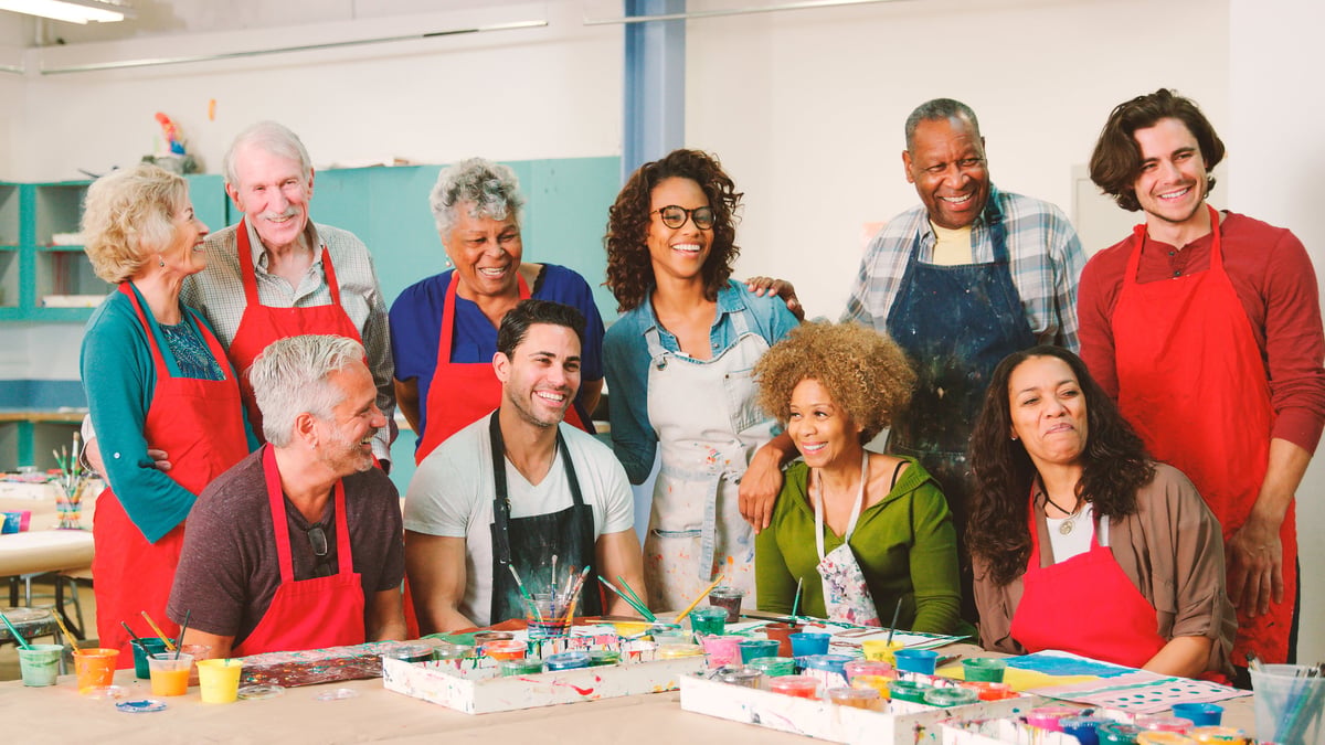 Adults attending a hands-on art class together at a community centre with a teacher